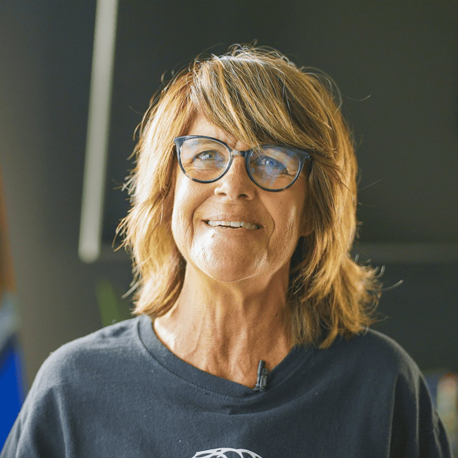 Artist Nina Haro standing in sunlight smiling